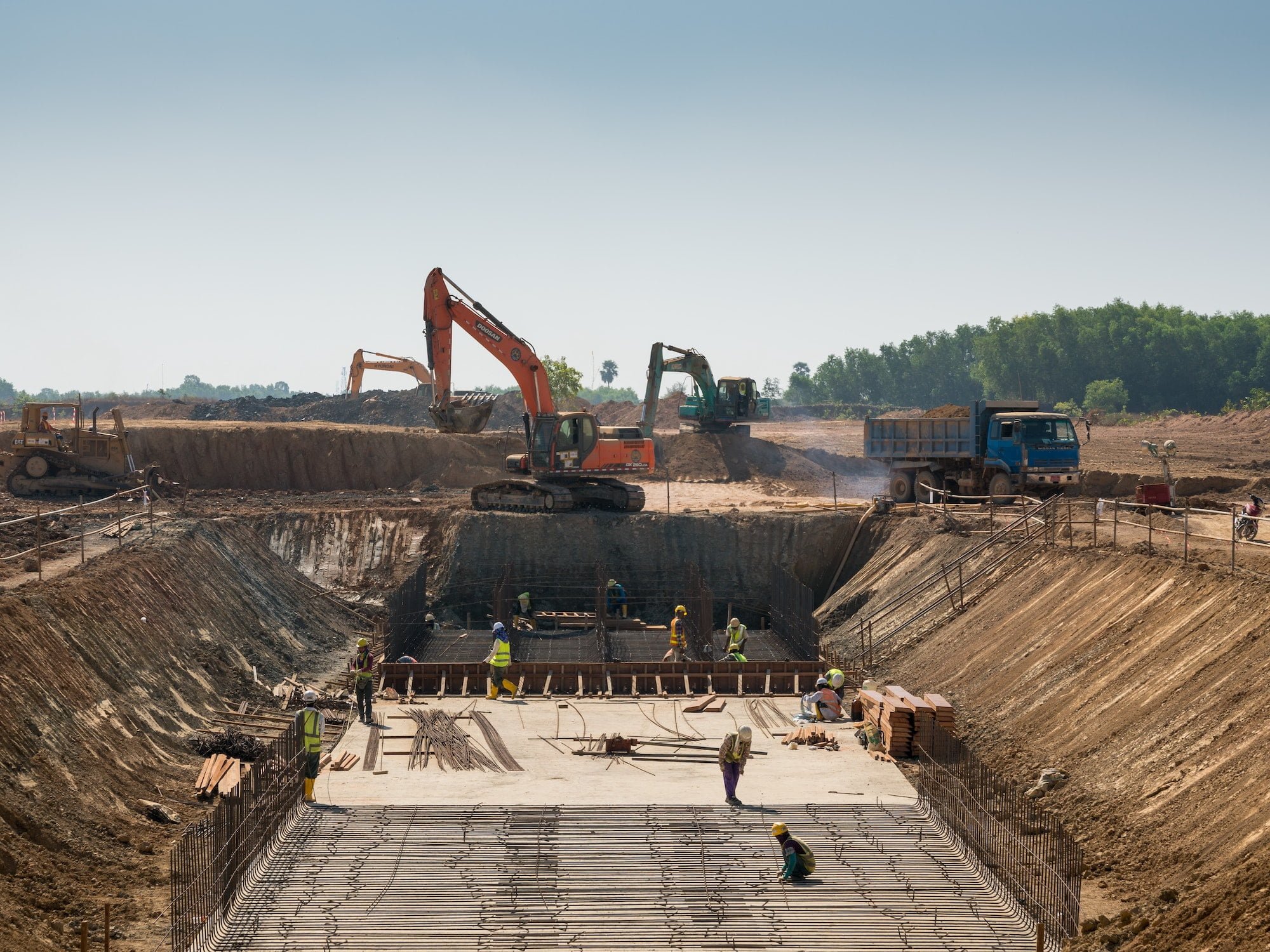 close-shot-of-heavy-machines-and-construction-workers-working-on-a-building.jpg